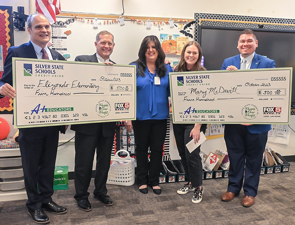 Nonprofit announces new leadership such as Ray Wilson on far left side presenting a check for A+ Educators partnership.